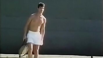 Tennis player likes to untie his penis stiff muscles after excercises with ball shooter machine and drop his load on his tennis racket